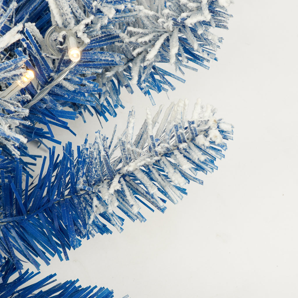 Blue flocked branch tips with a warm white LED light