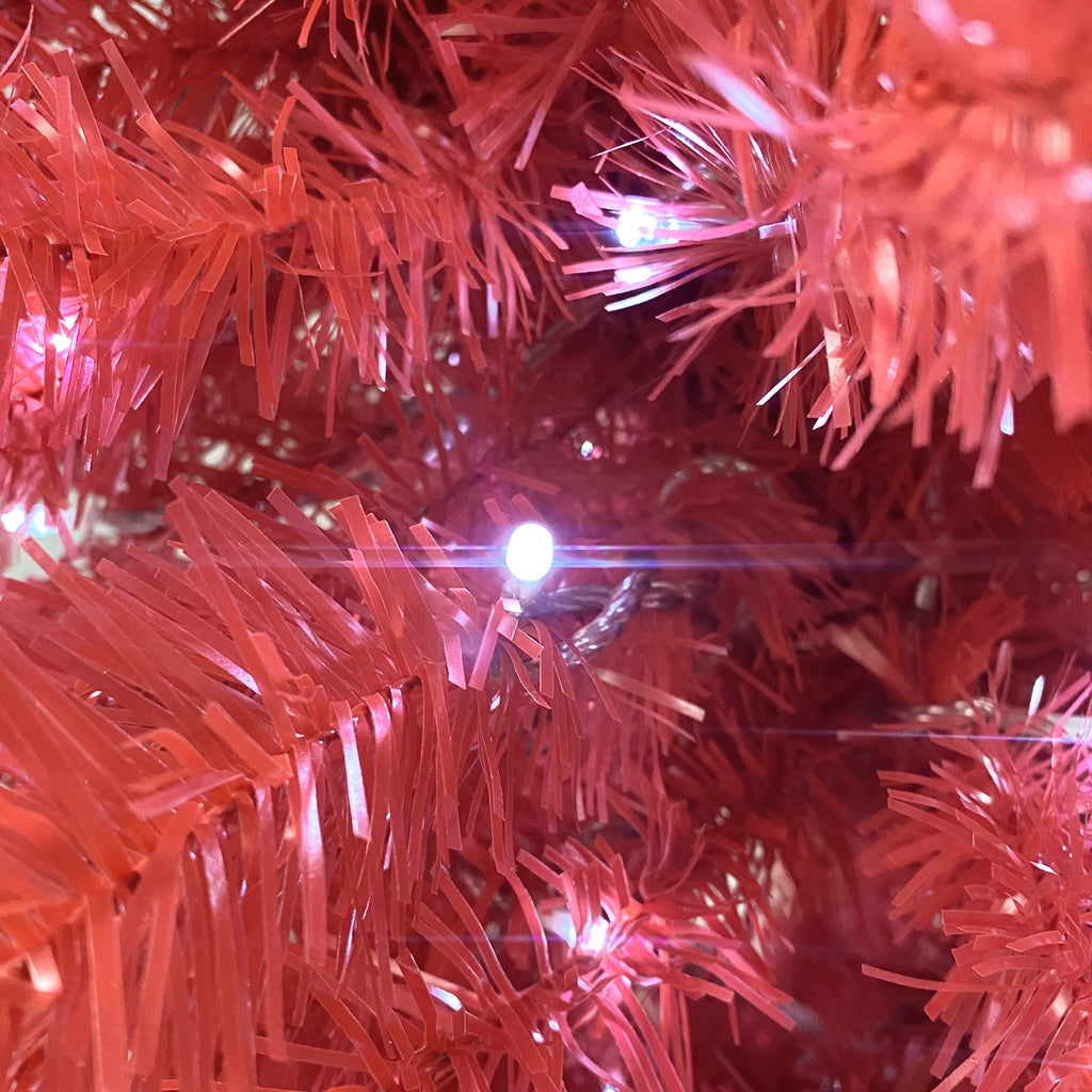 Red branch tips with a glowing LED light, close-up