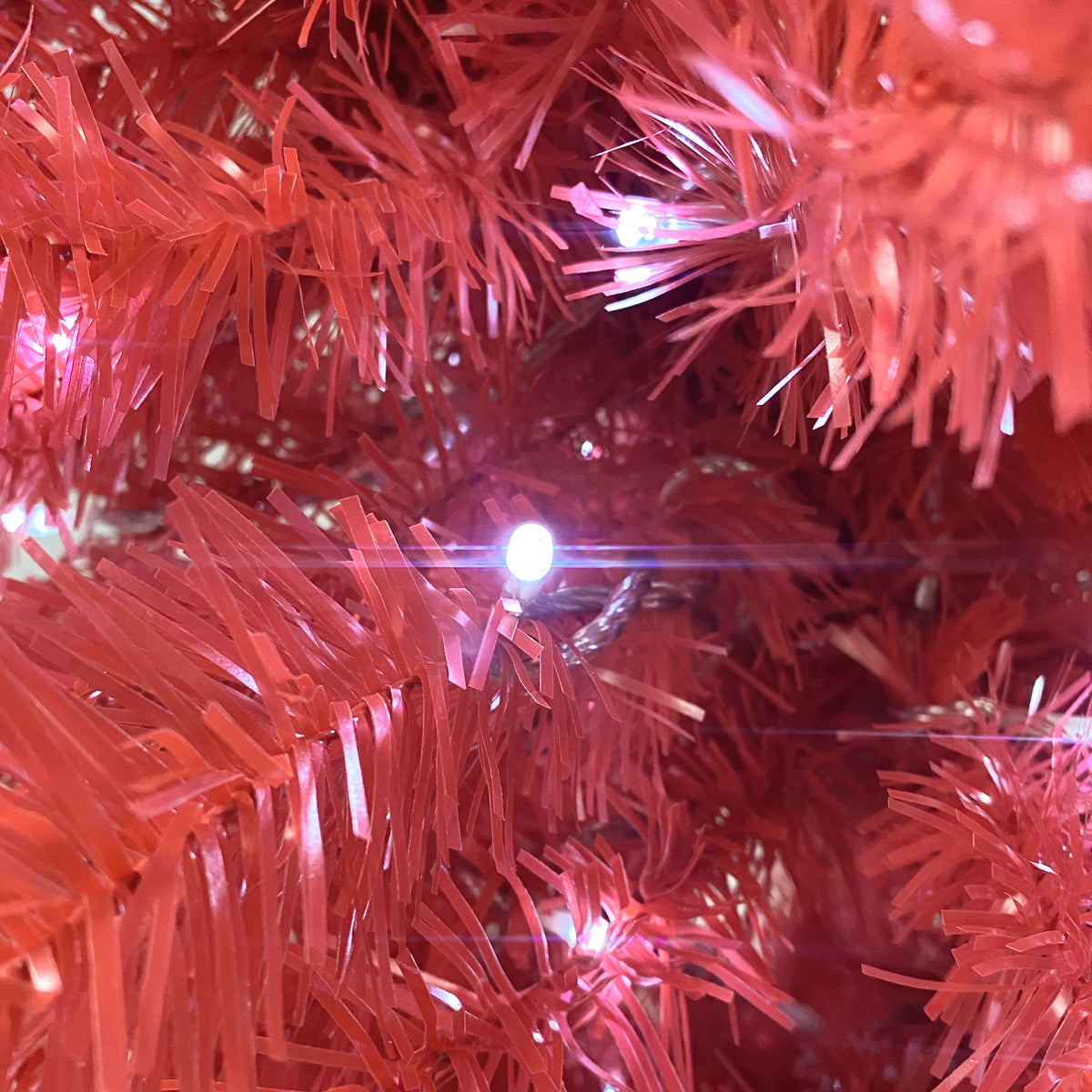 Red branch tips with a glowing LED light, close-up