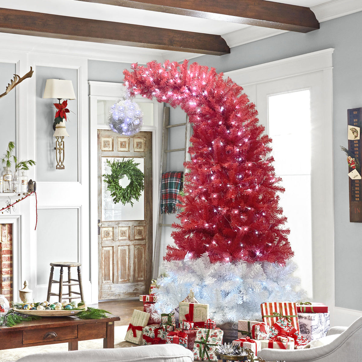 Santa hat tree in a living room with presents and a wreath