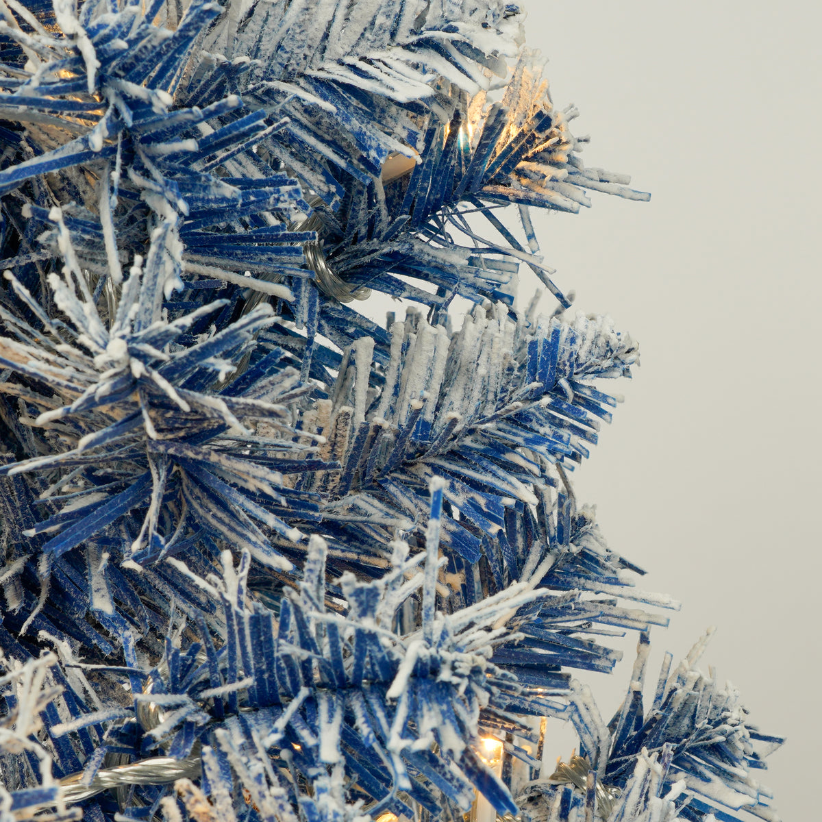 Blue flocked branch detail with an LED light