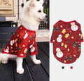 White dog wearing a red festive Christmas dog outfit with holiday prints by DealSpark