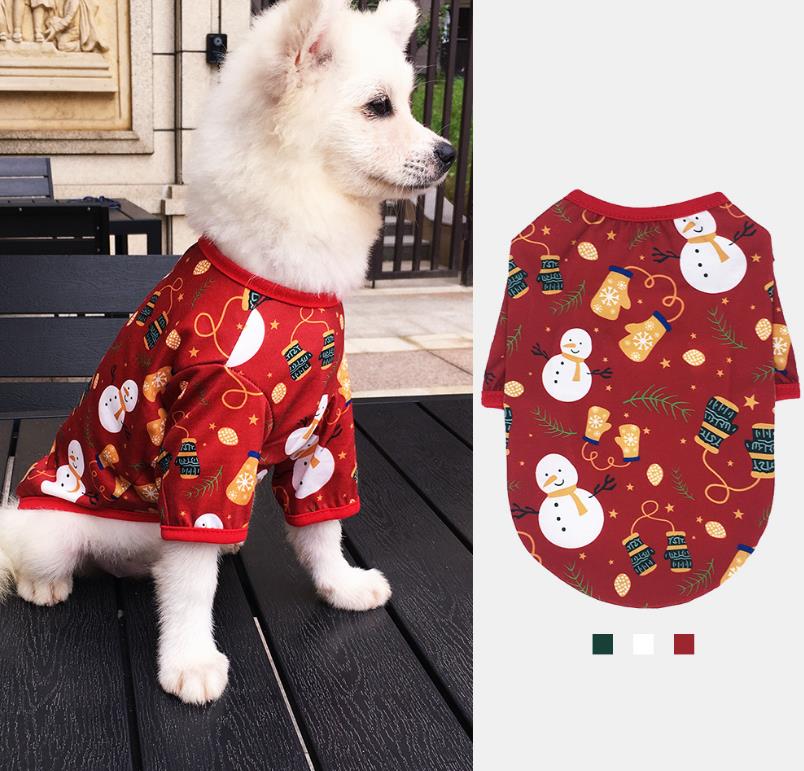 White dog wearing a red festive Christmas dog outfit with holiday prints by DealSpark
