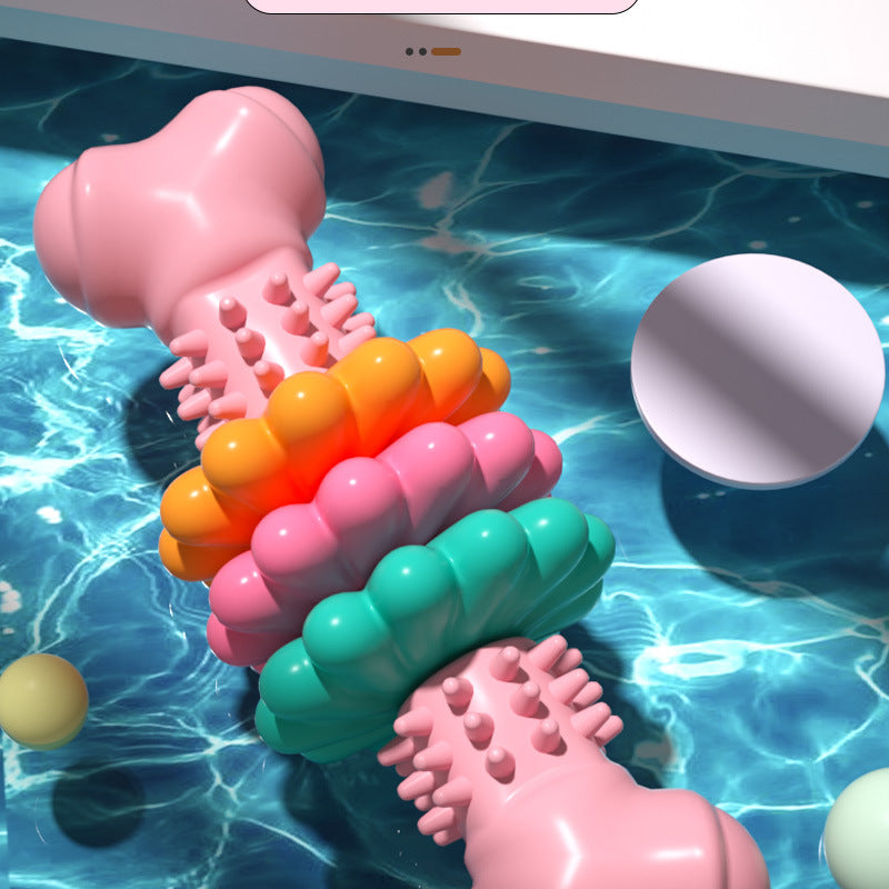 Pink dog chew bone toy floating in a pool
