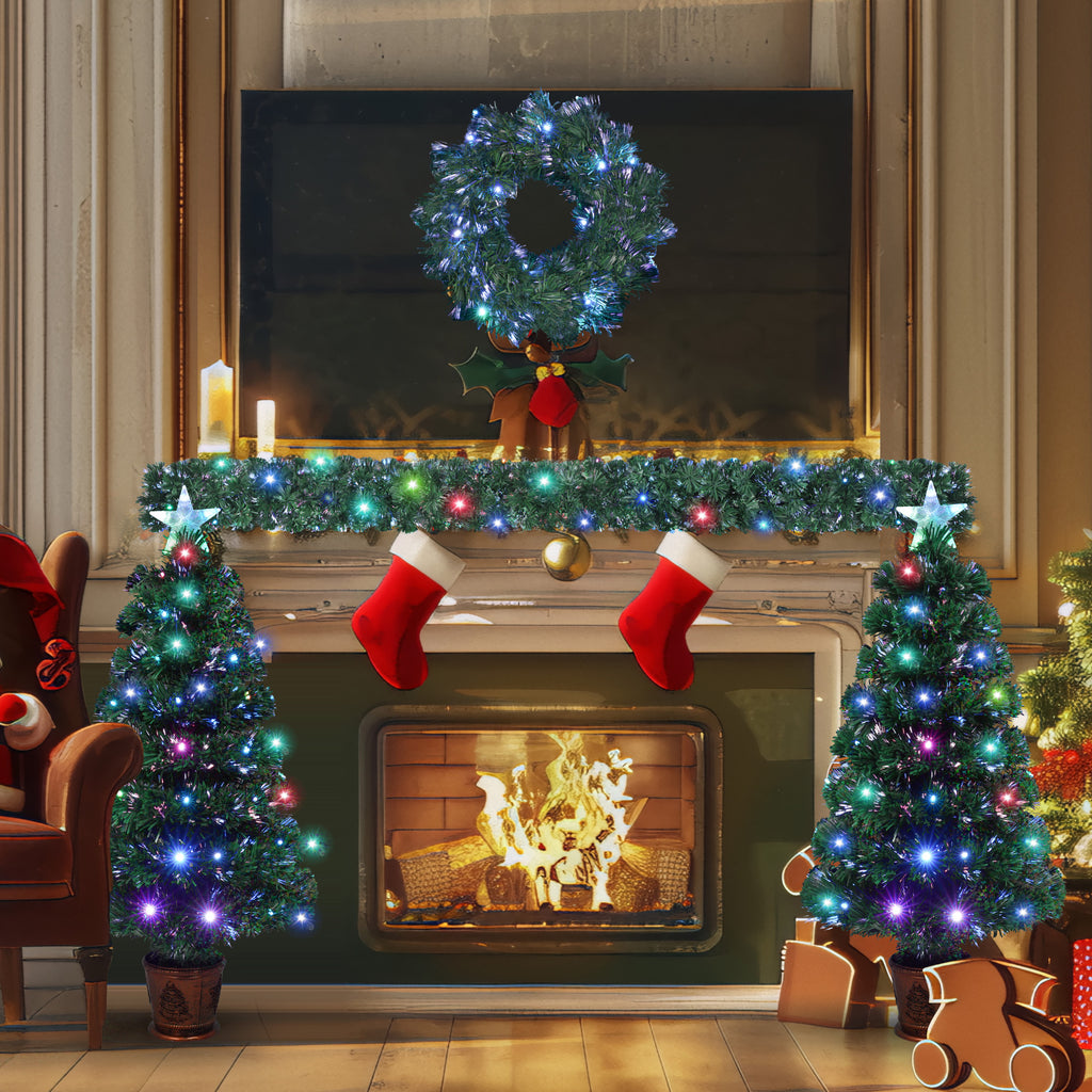 Full Christmas set by a fireplace — two lit trees, wreath and garland by DealSpark