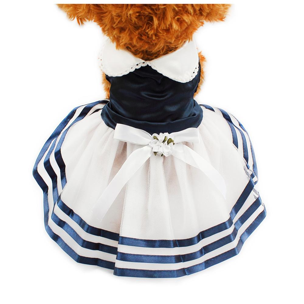 Small dog wearing a navy sailor tutu dress with a white lace collar by DealSpark
