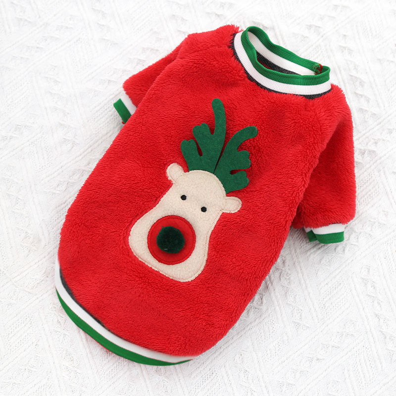 Red fleece dog sweater with reindeer face on a white fur background
