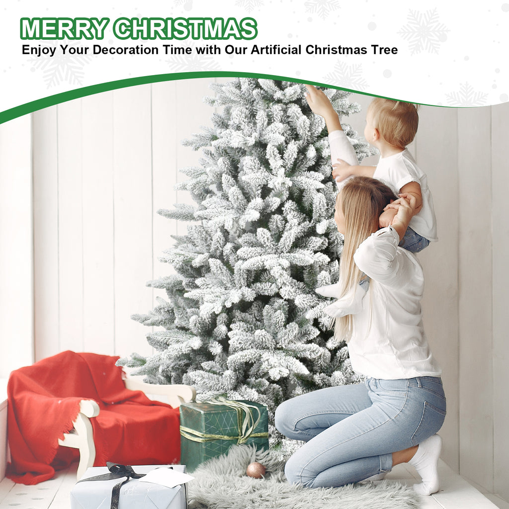 Family decorating the snow-flocked Christmas tree