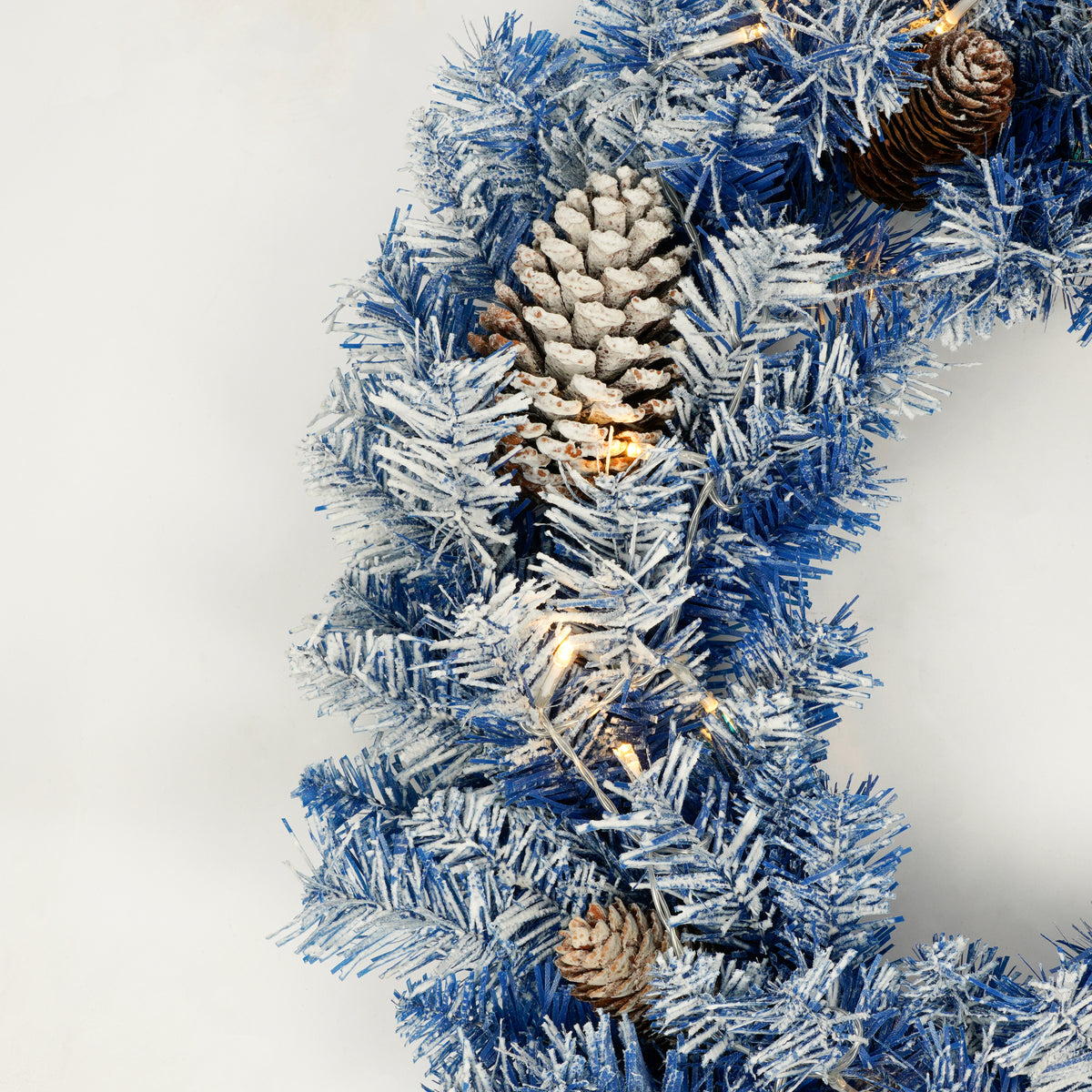 Blue flocked Christmas wreath with pine cones
