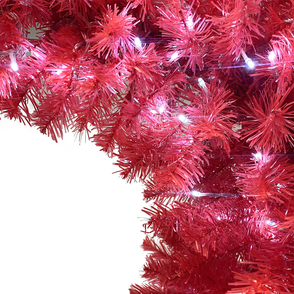 Lit red branches of the Santa hat tree, close-up