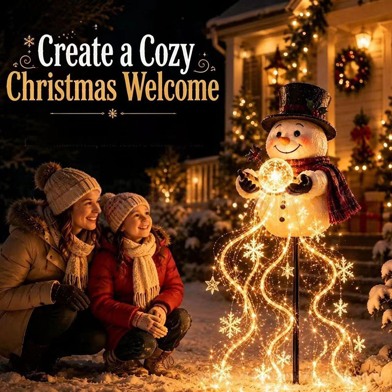 Family admiring the snowman magic fountain light in the snow