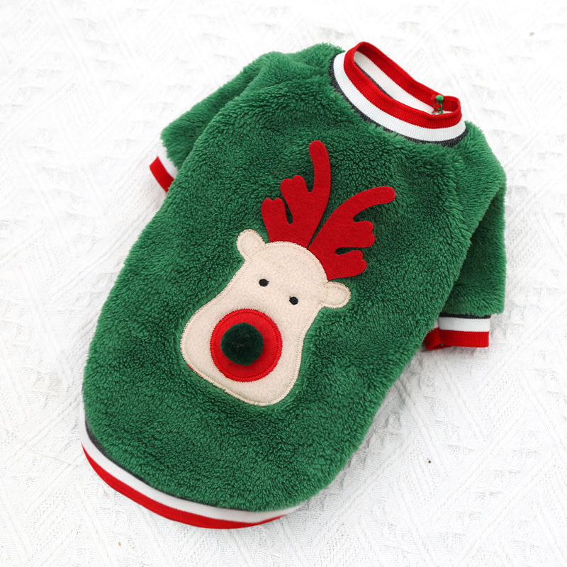 Green fleece dog sweater with reindeer face on a white fur background