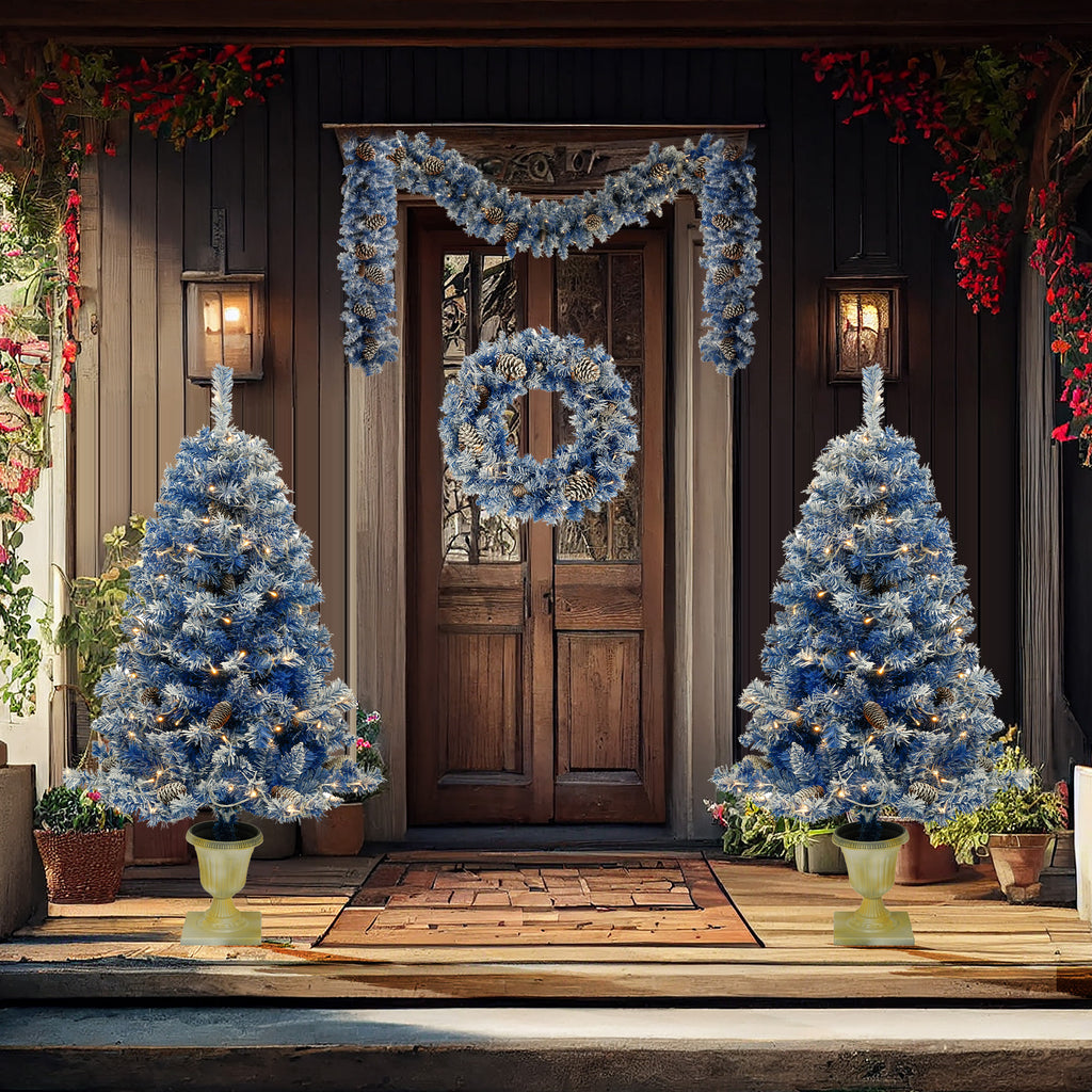 Blue flocked entrance trees and wreath on a porch at dusk