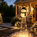 Solar snowman garden light glowing in a front yard at night by DealSpark