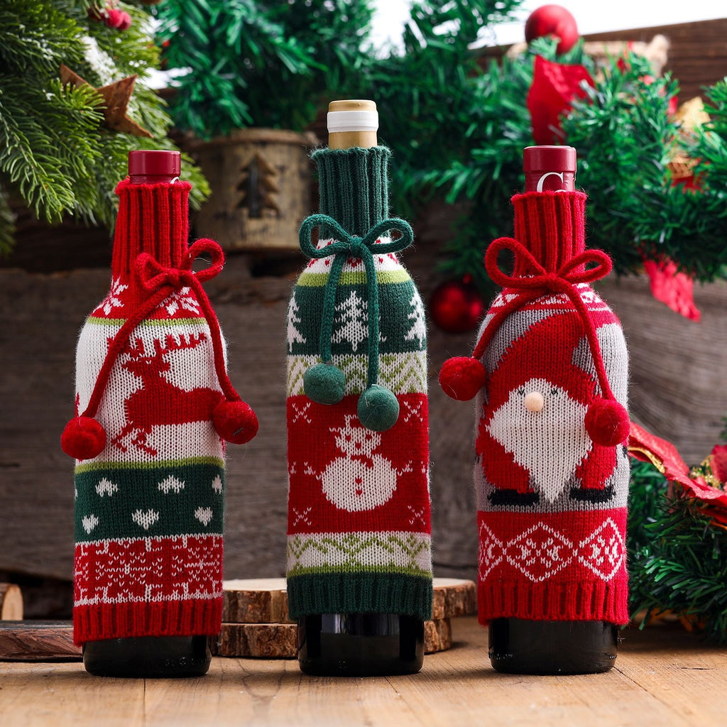 Christmas wine bottle covers on bottles by a decorated tree