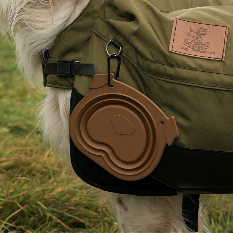Folding dog bowl clipped to a dog hiking backpack