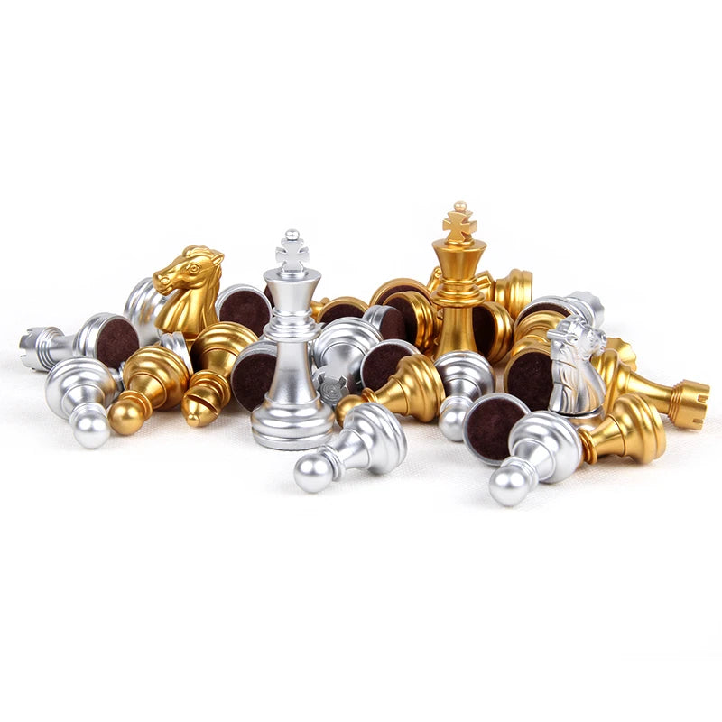 Gold and silver metal chess pieces with felt bases