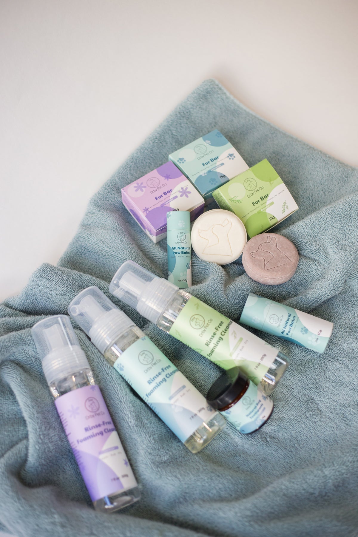 Drby pet care range flat lay with rinse-free foaming cleanser bottles