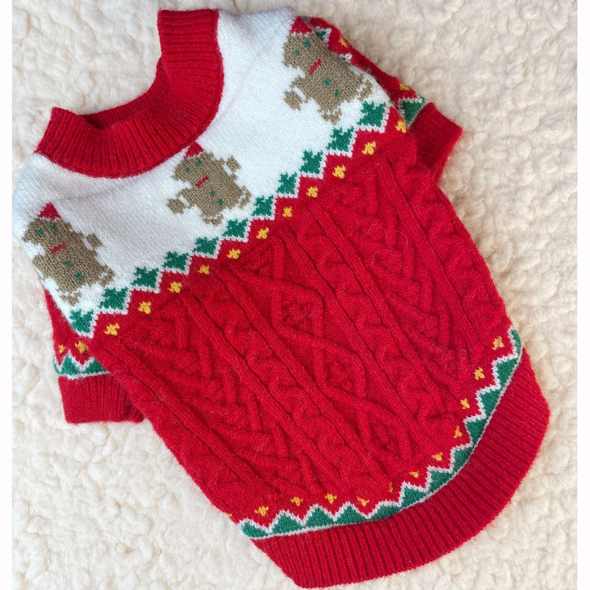 Red Christmas dog sweater flat lay showing the cable knit