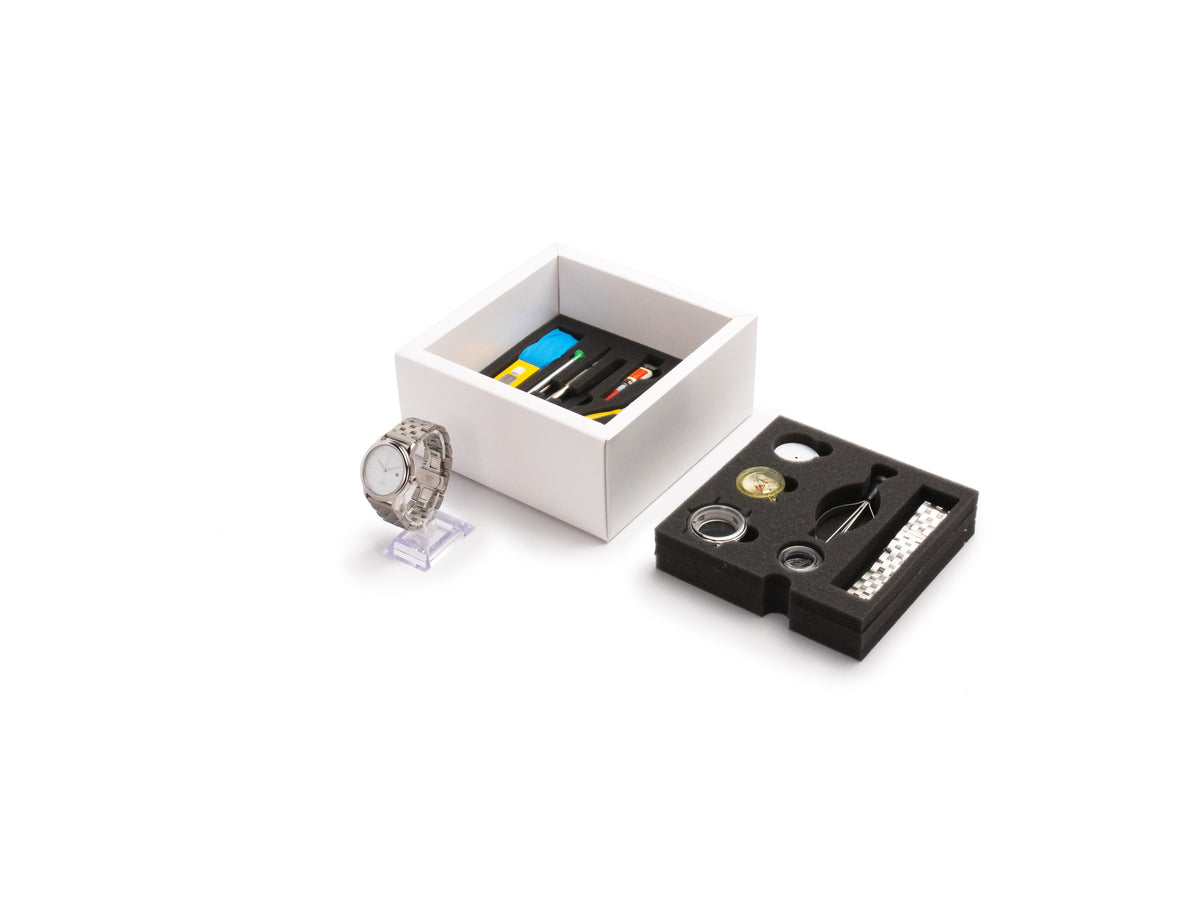 Newton watchmaking kit box with parts and tools
