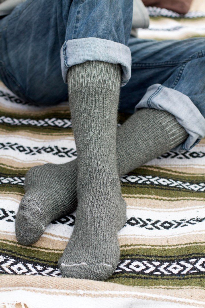 Grey alpaca socks worn with rolled-up jeans