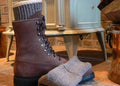 Superwarm alpaca socks next to a winter boot by a wood stove by DealSpark