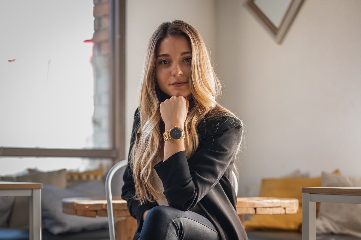 Woman wearing the finished Eiffel mechanical watch at a table